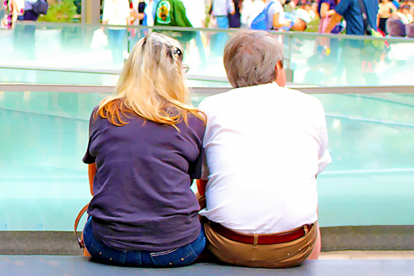 プールサイドに座る老夫婦